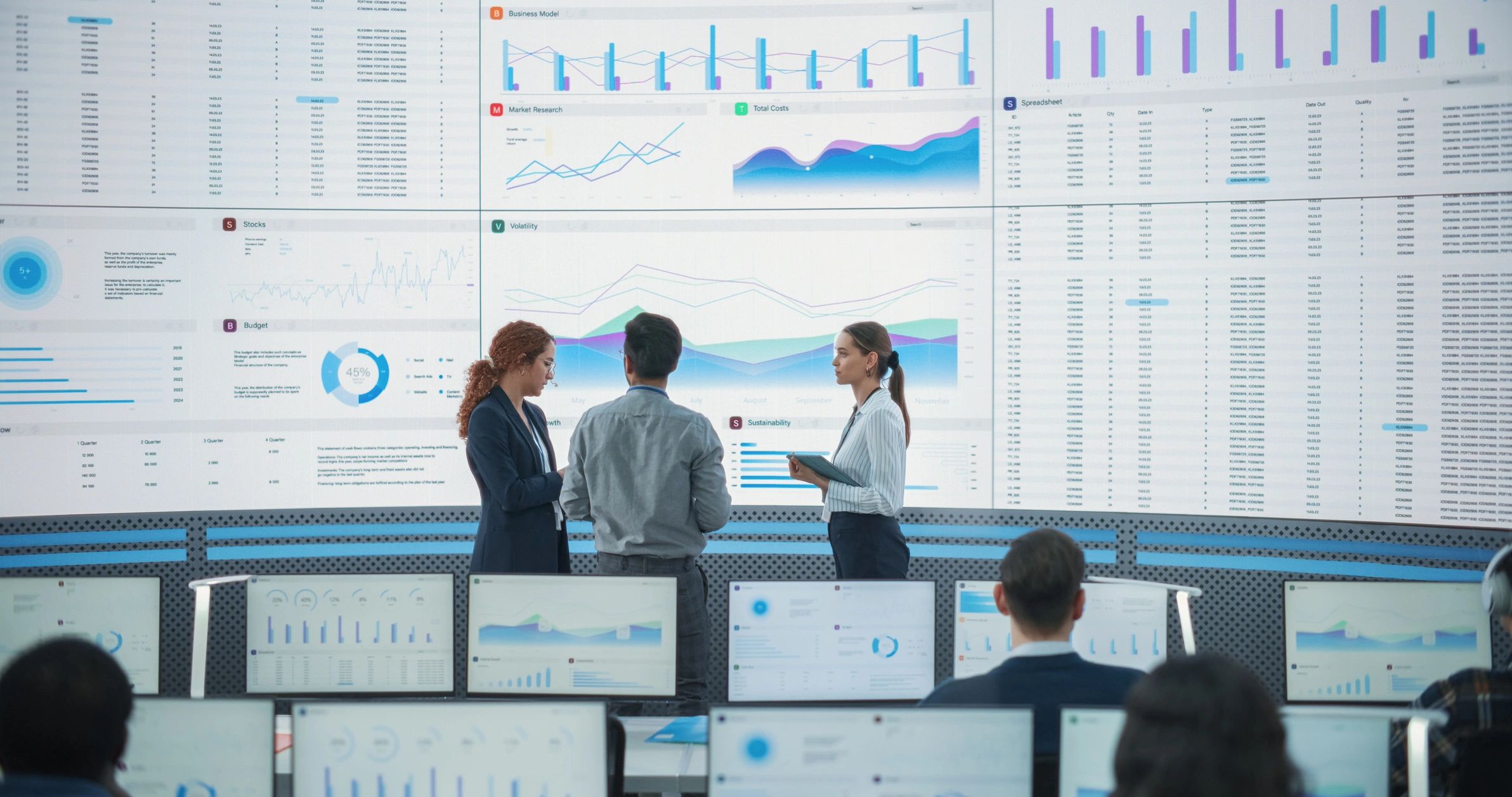 Technology team reviewing data and infrastructure performance in a modern operations room